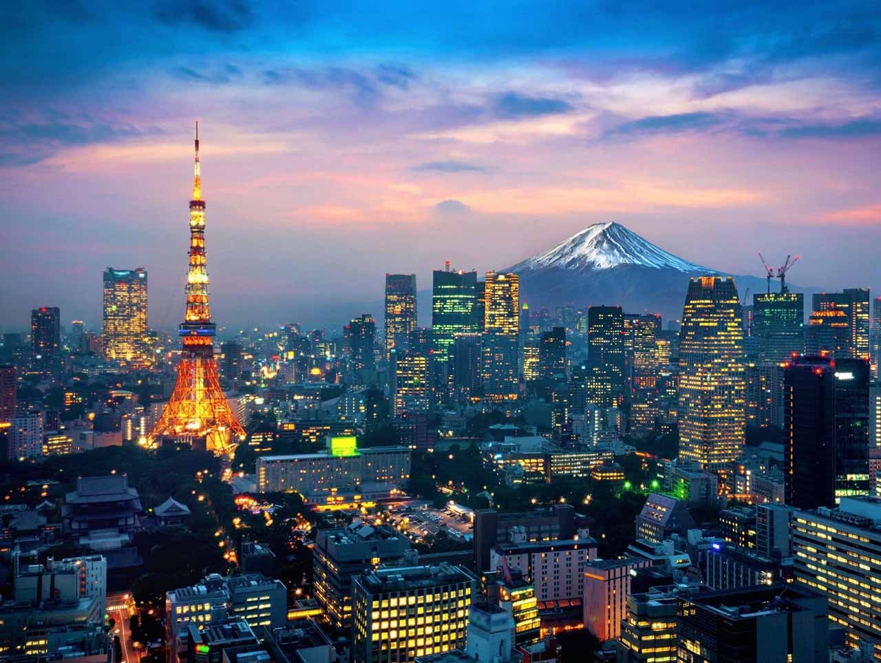 View over Tokyo at dusk with Tokyo Tower and Mount Fuji in the background
