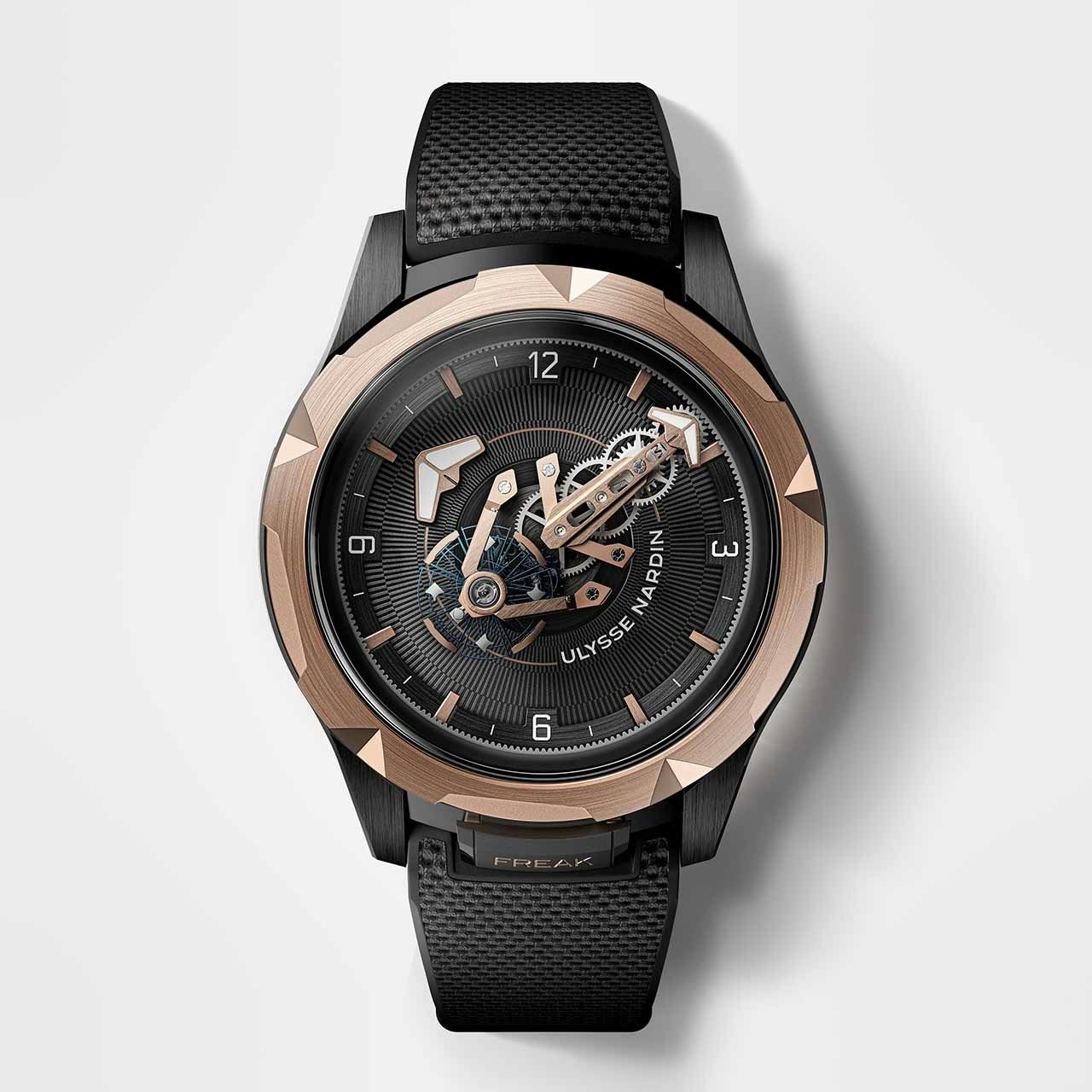 Top down view of a black and rose gold watch on a white background