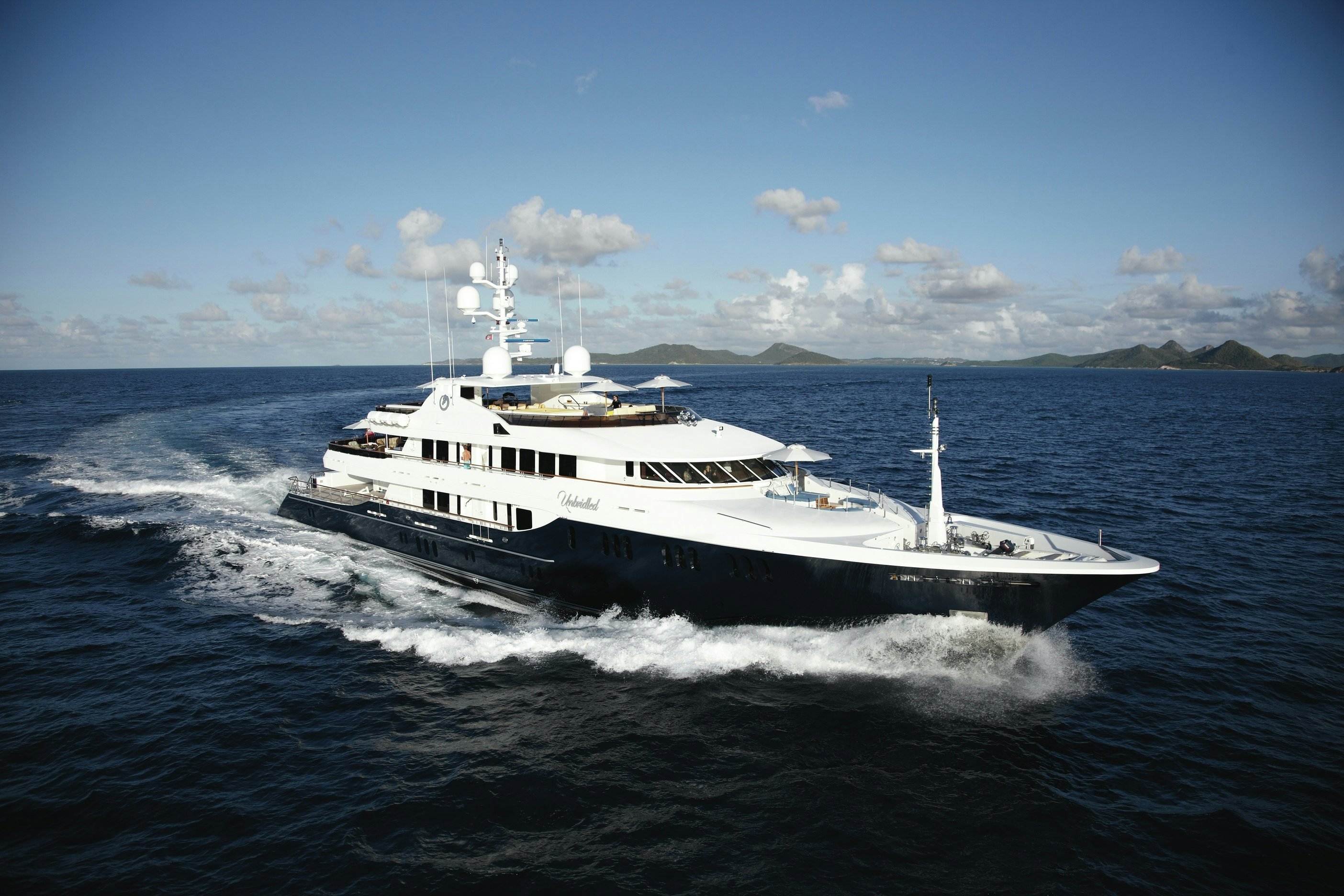 Side profile of luxury charter yacht UNBRIDLED on the water