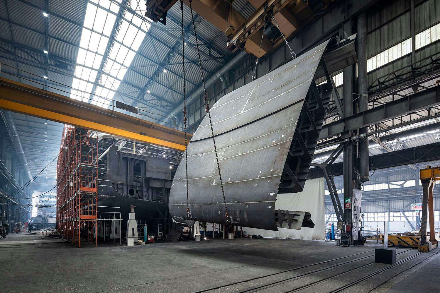 image of the Wider shipyard inside during some sort of yacht construction