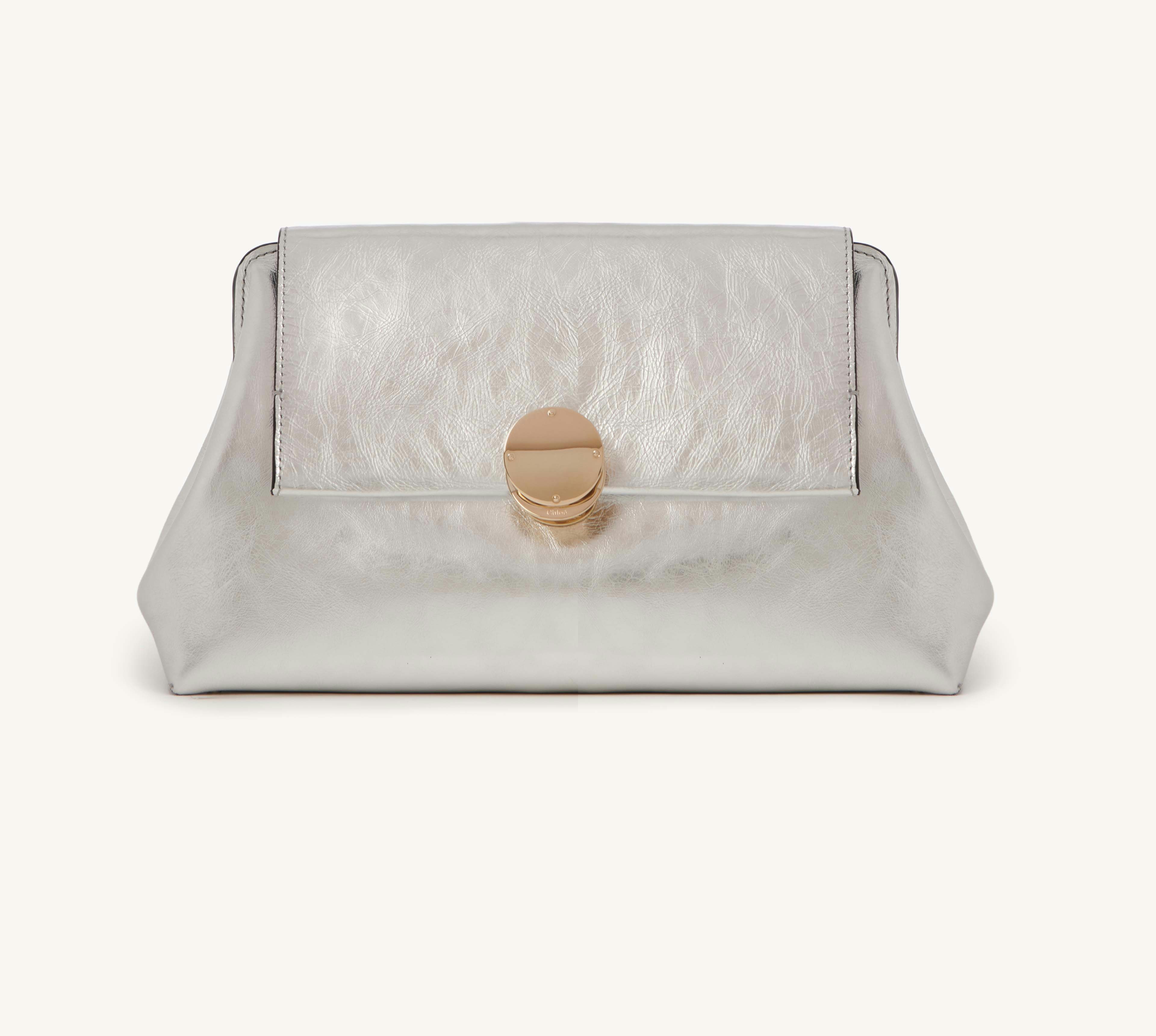 Women&#039;s silver clutch bag with gold clasp detail