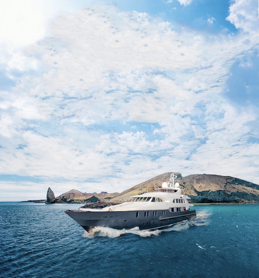 Yacht-Cruising-blue-water-and-sky-and-cliffs