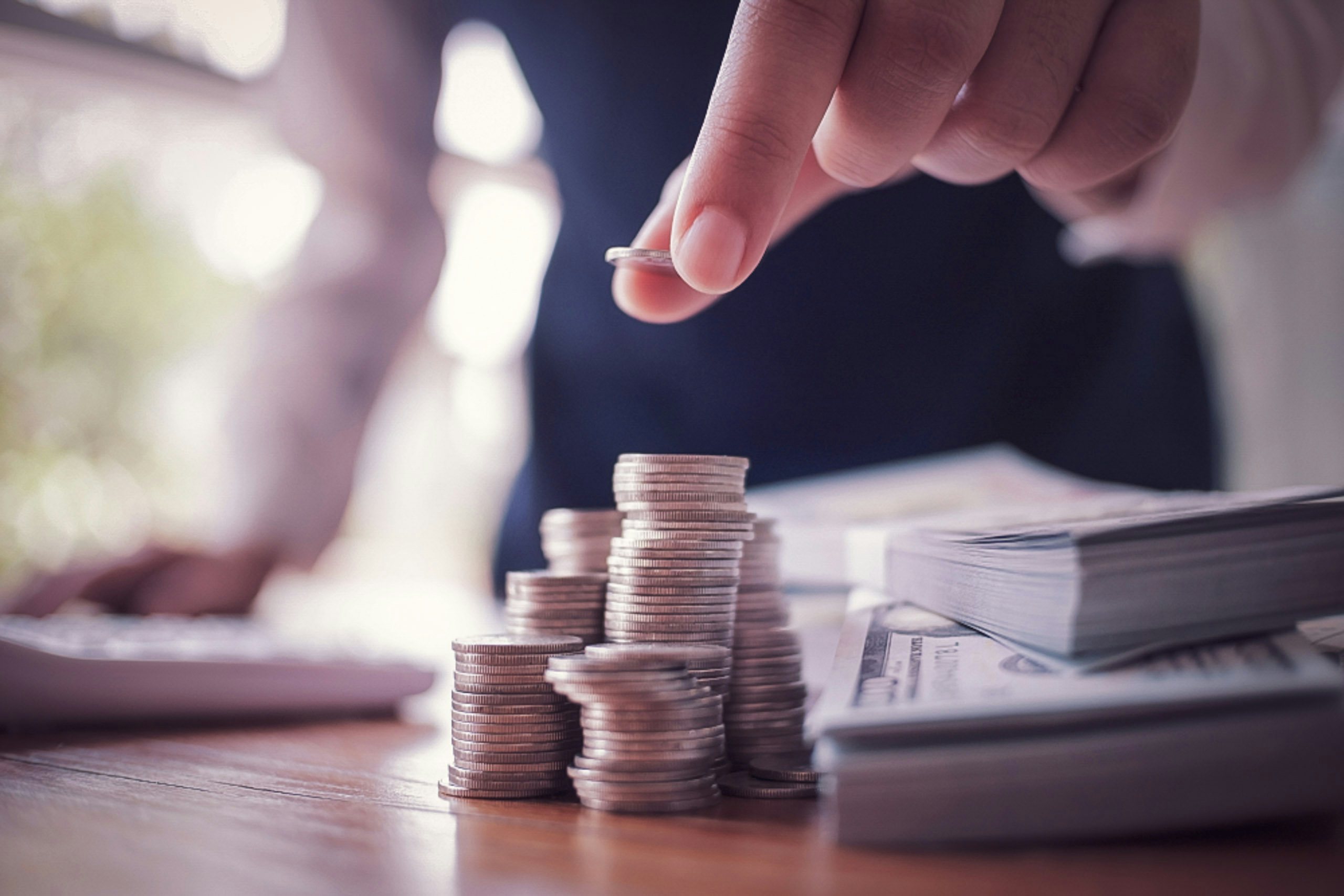 Yacht Management Financial Expertise Business person placing coins on top of desk