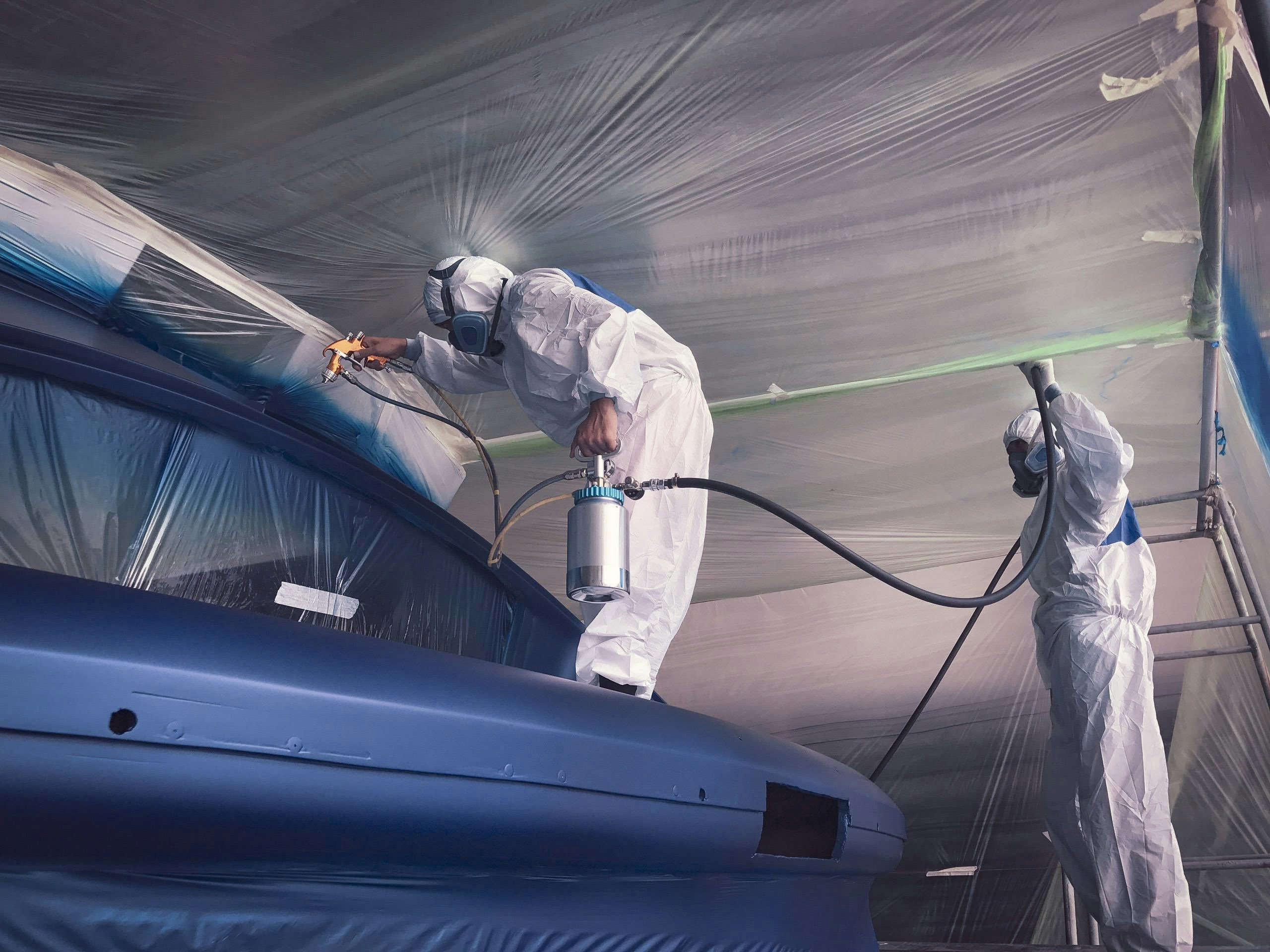 Yacht_Management-Maintenance_and_Repairs Shipyard workers painting yacht