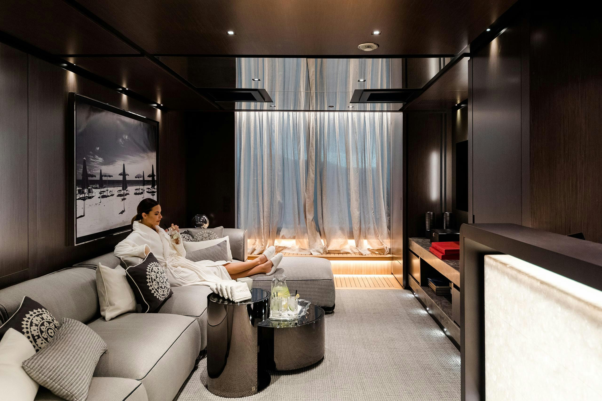 Woman enjoying privacy and calm on board yacht for sale with beach club