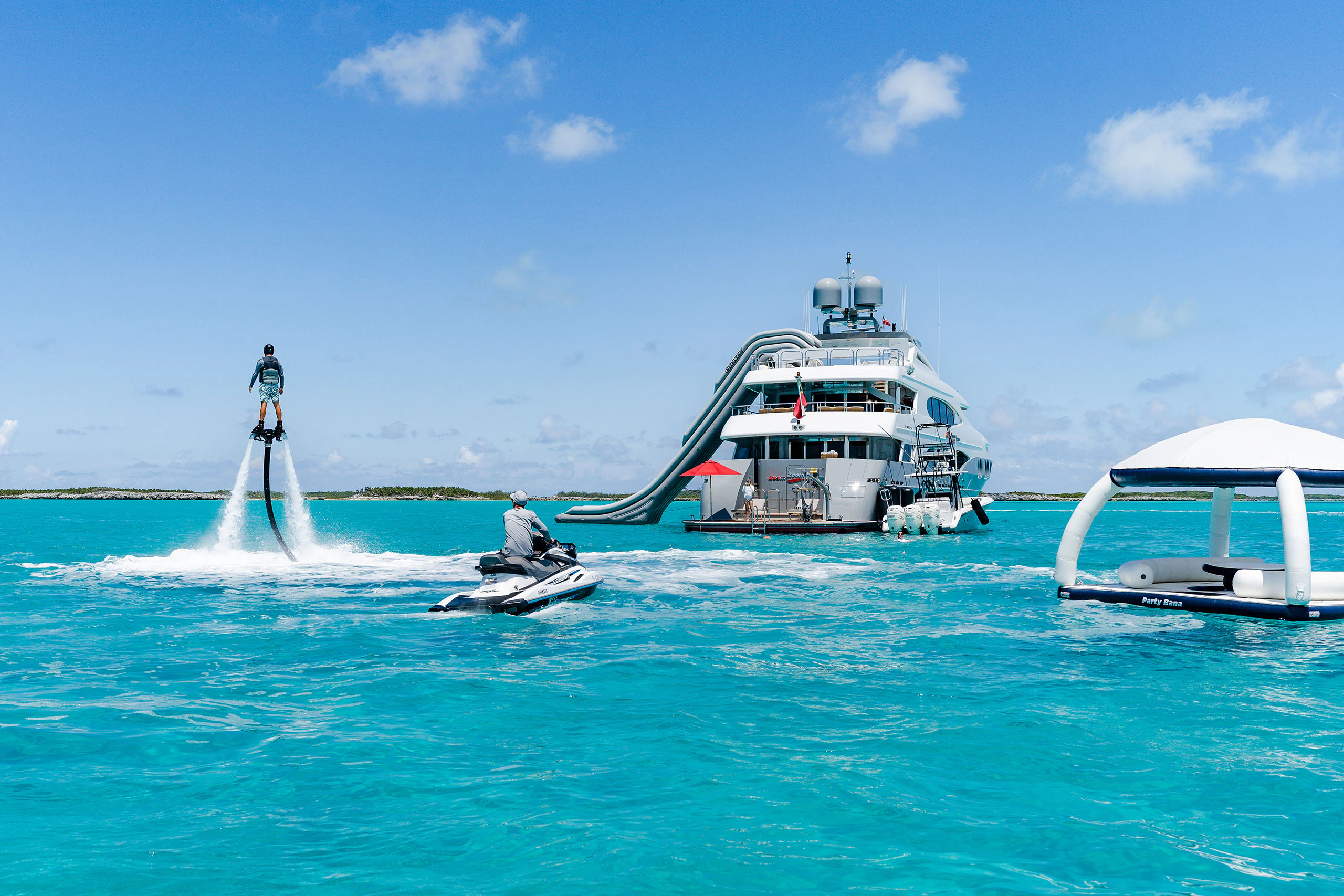 Motor yacht Zoom Zoom Zoom anchored in the Bahamas with toys deployed and in use