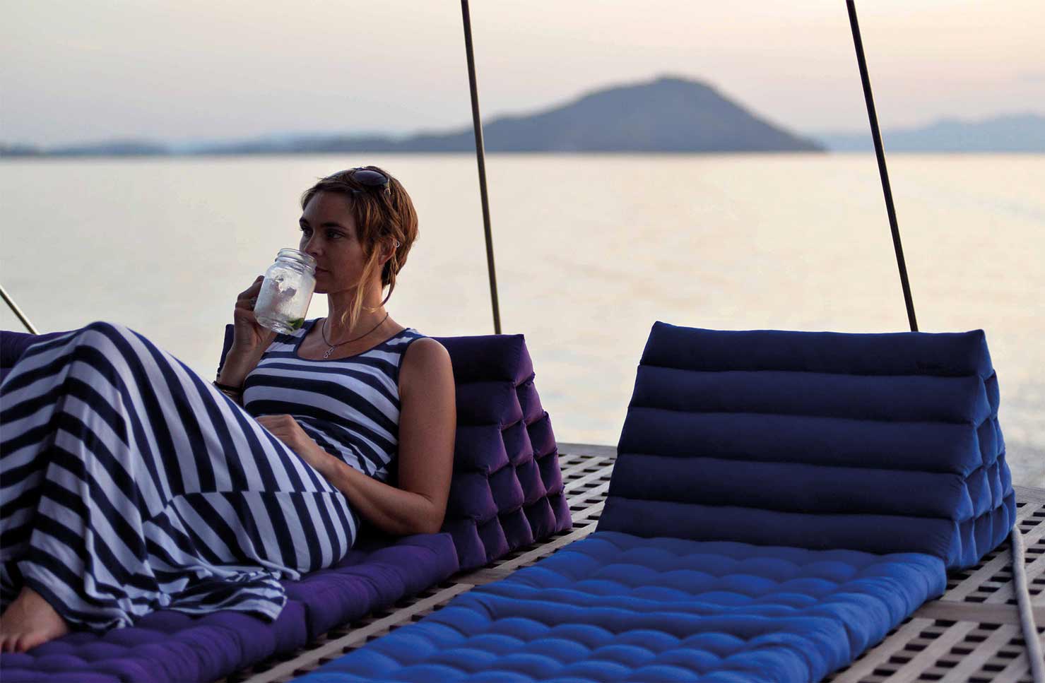 Lady lounging on the deck of Dunia Baru