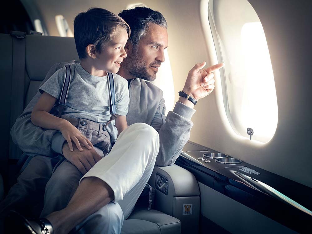 Father and son looking out of net jets plane