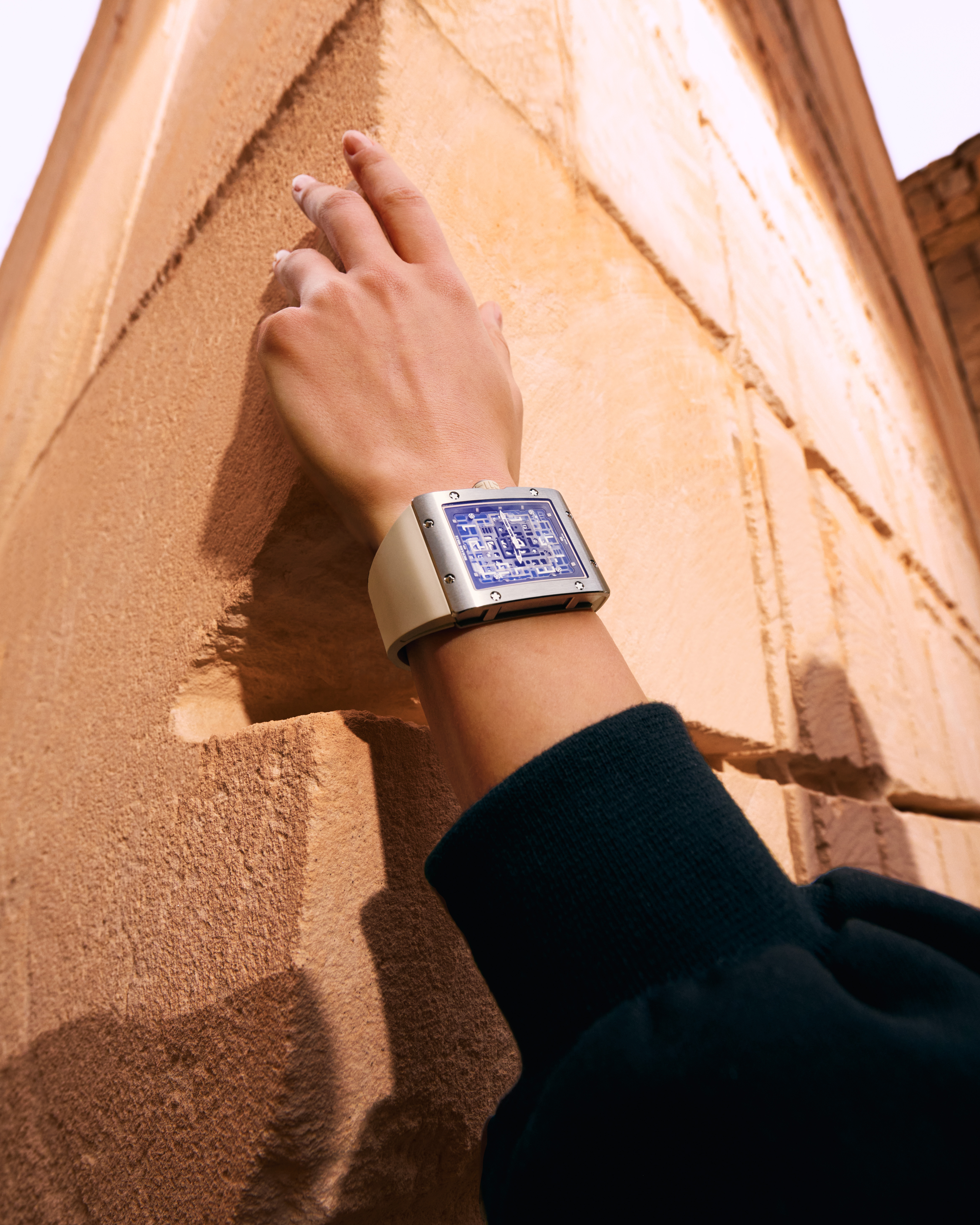 Model's hand on a wall wearing the Richard Mille iconic RM 016 timepiece