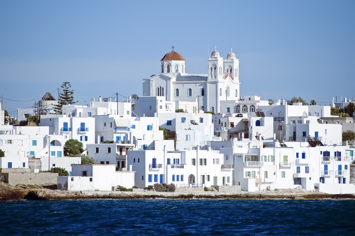 Traditional white-washed Greek village by the sea, perfect for a cultural stop on your Greek yacht charter.