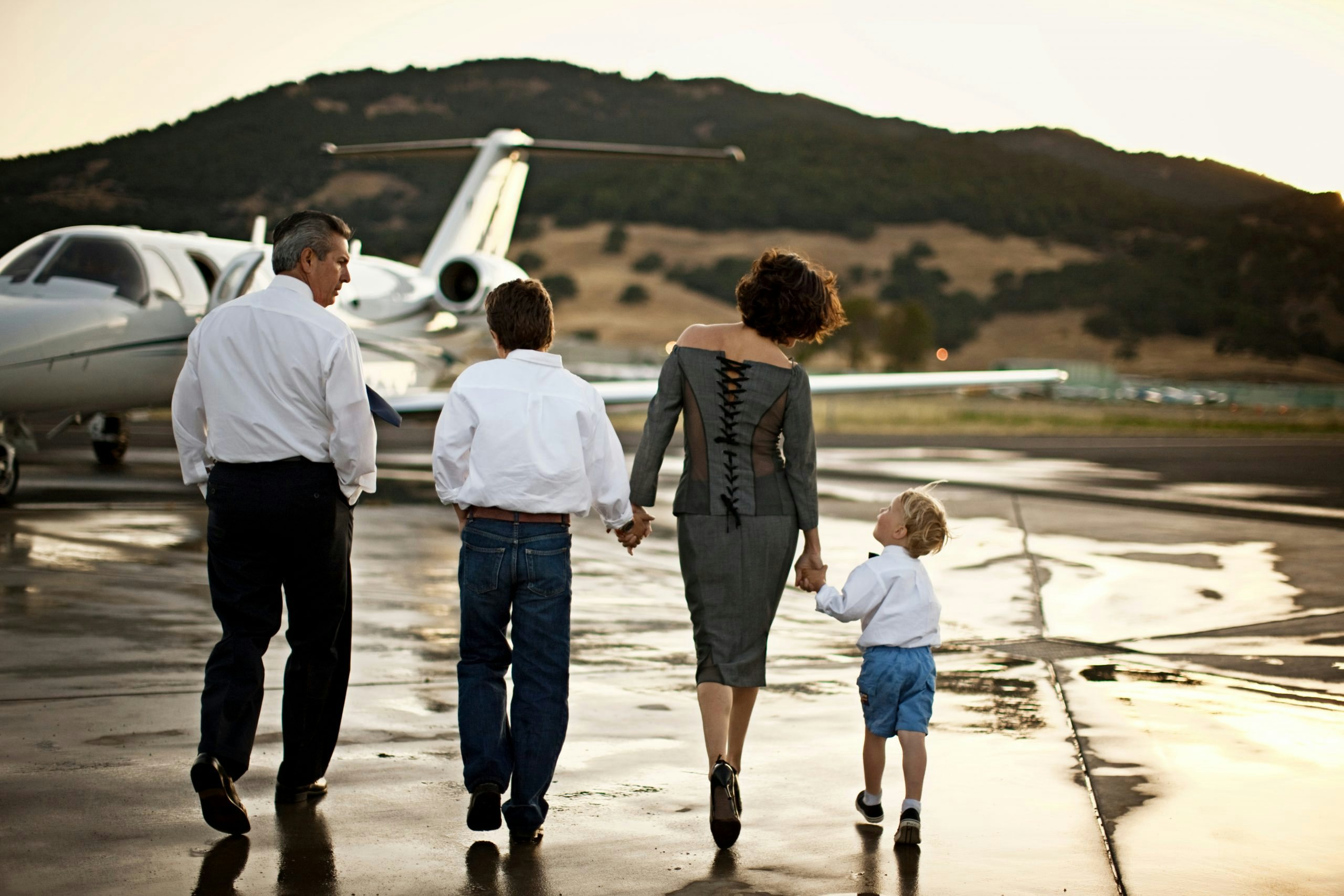 Family walking to a private jet