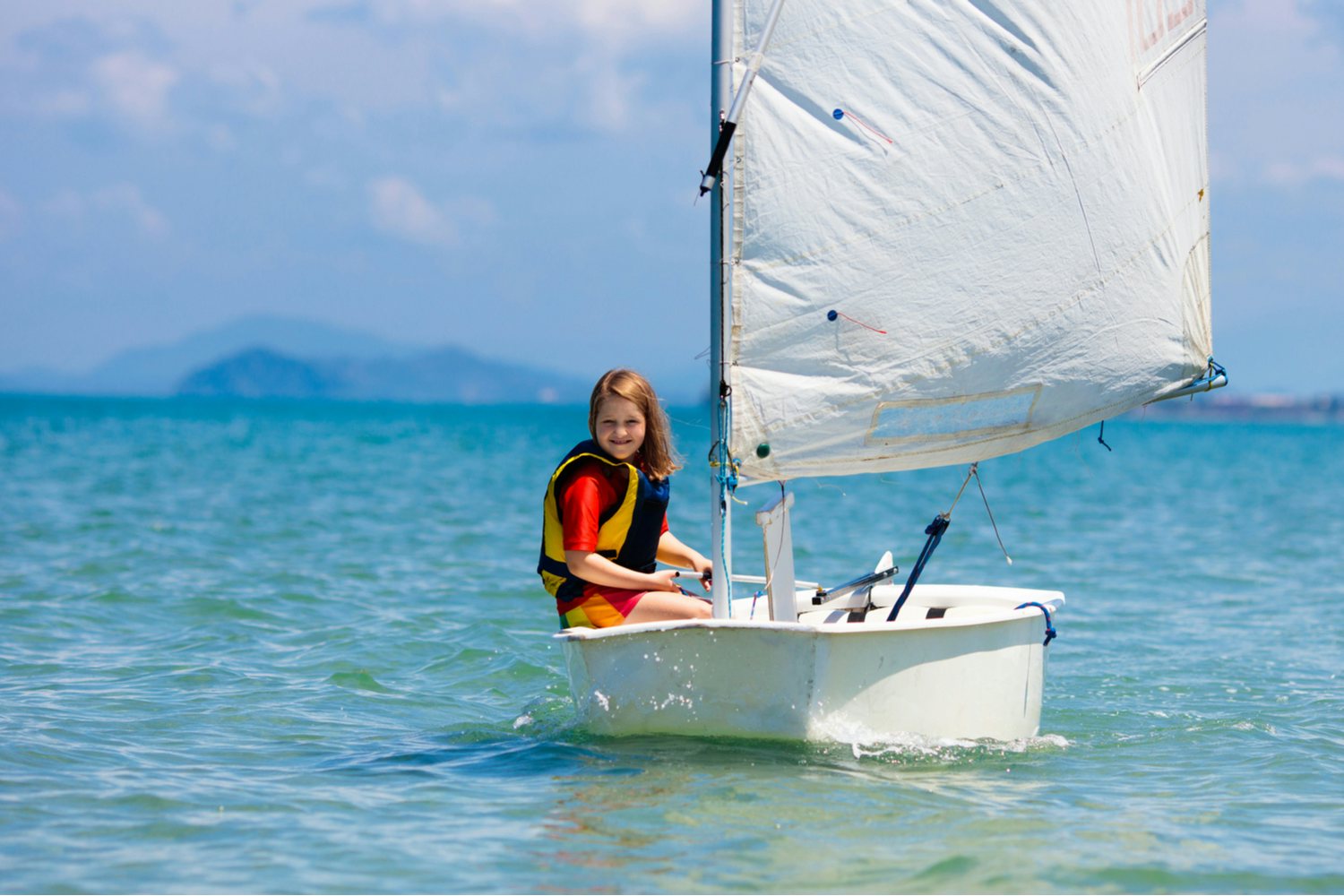 Little girl learning how to sailing in the Caribbean
