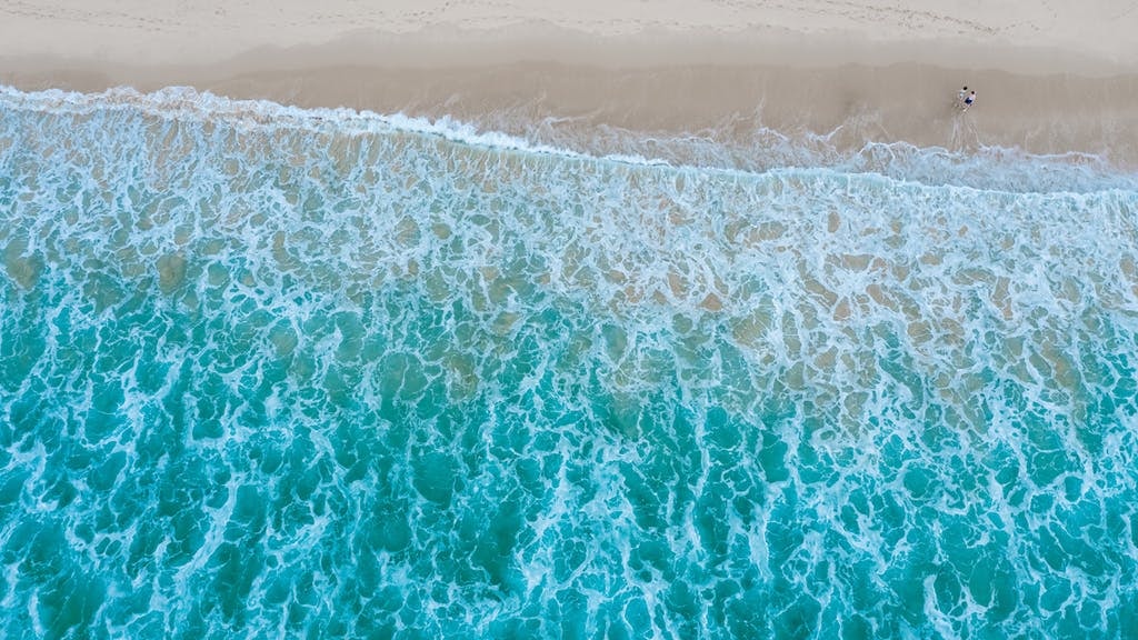 Aerial,Top,View,Of,Sandy,Beach,With,Travelling,Tourists,In