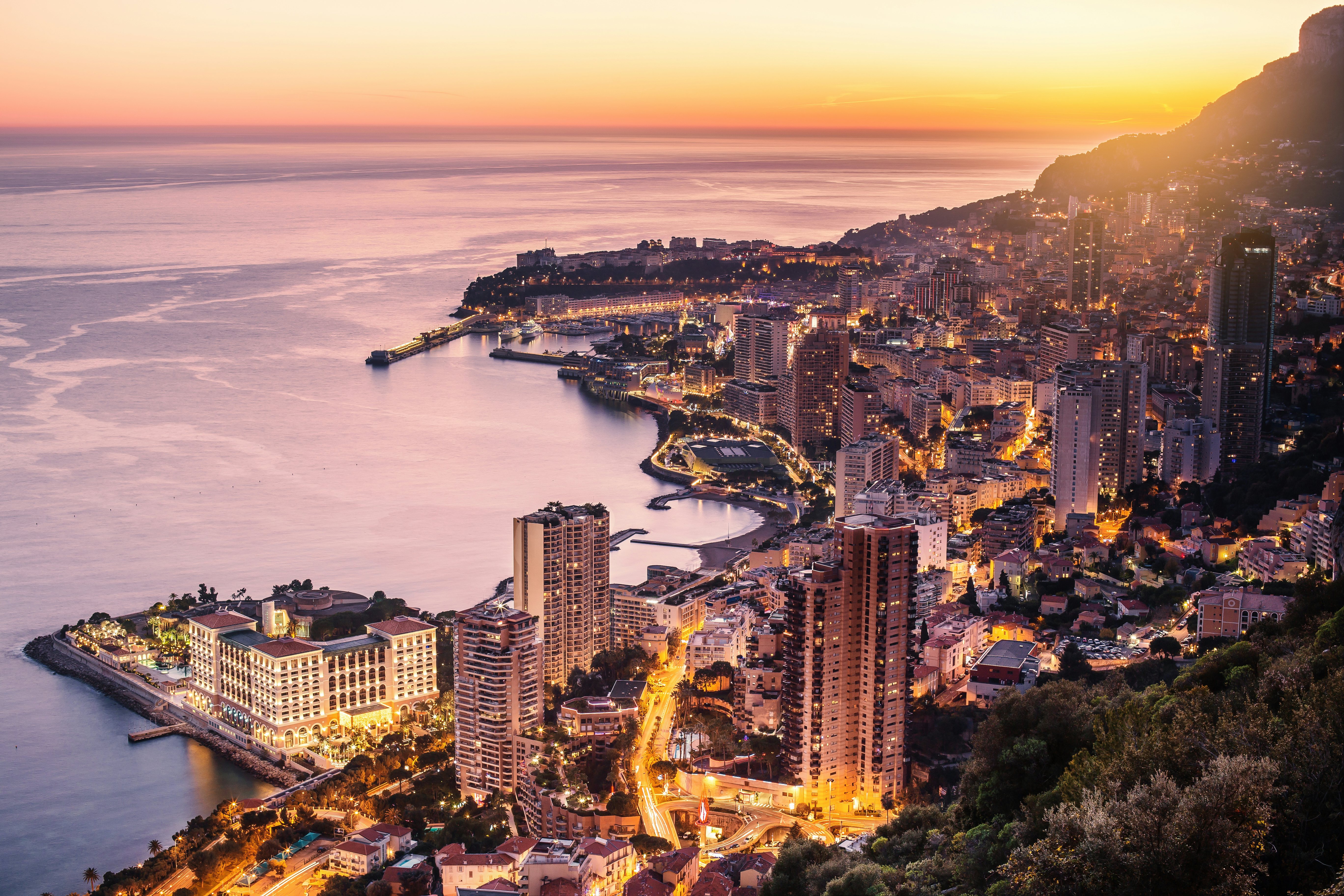 Monaco Sunset: Charter a Yacht for the Ultimate Grand Prix Experience A breathtaking top view of Monaco at sunset, the perfect backdrop for chartering a yacht during its best event the Monaco Grand Prix.