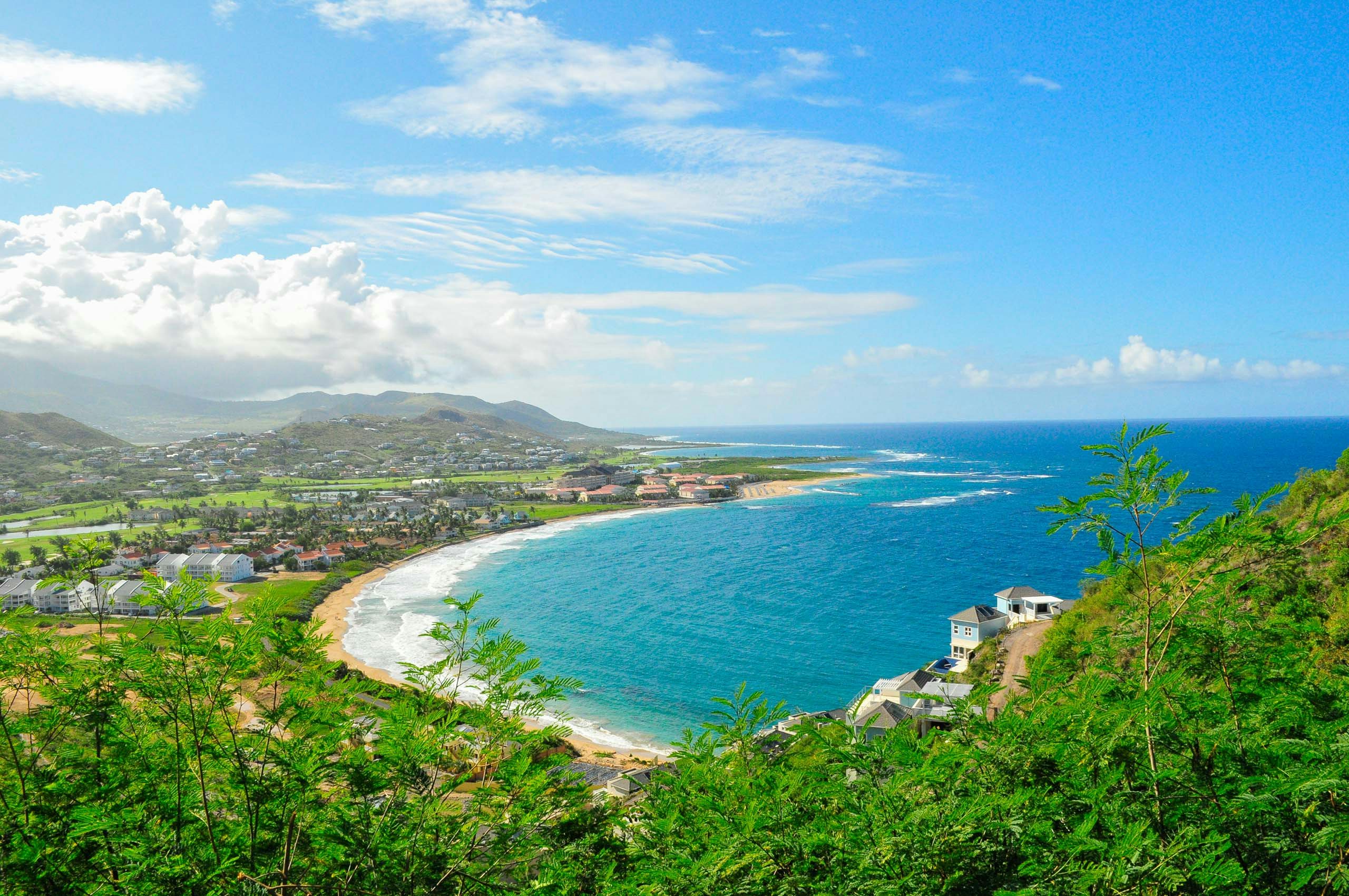 A mesmerizing aerial view of St. Kitts in the Caribbean Leeward Islands, showcasing the pristine beach, turquoise waters, and tropical beauty from above.