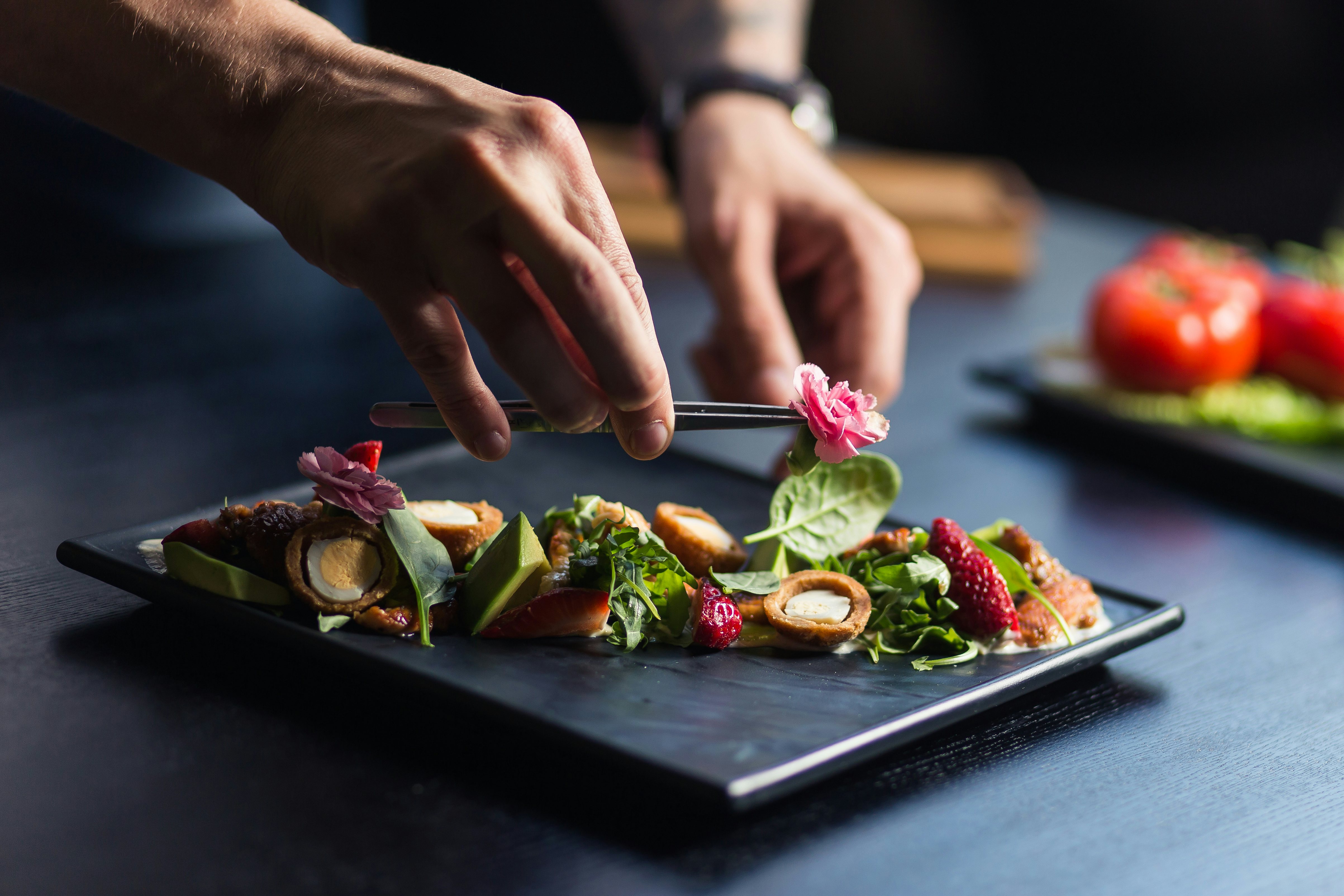 Chef,Finishing,Her,Plate,And,Almost,Ready,To,Serve,At Restaurant food