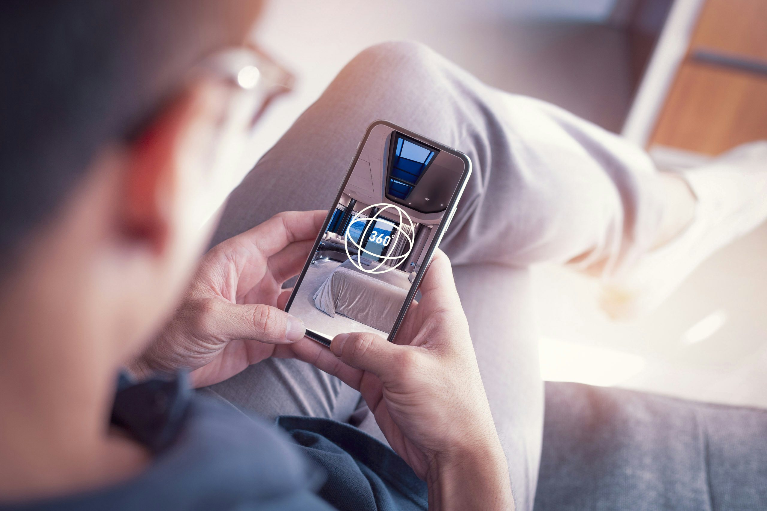 Virtual Tours Man enjoying virtual tour of charter yacht on his mobile phone