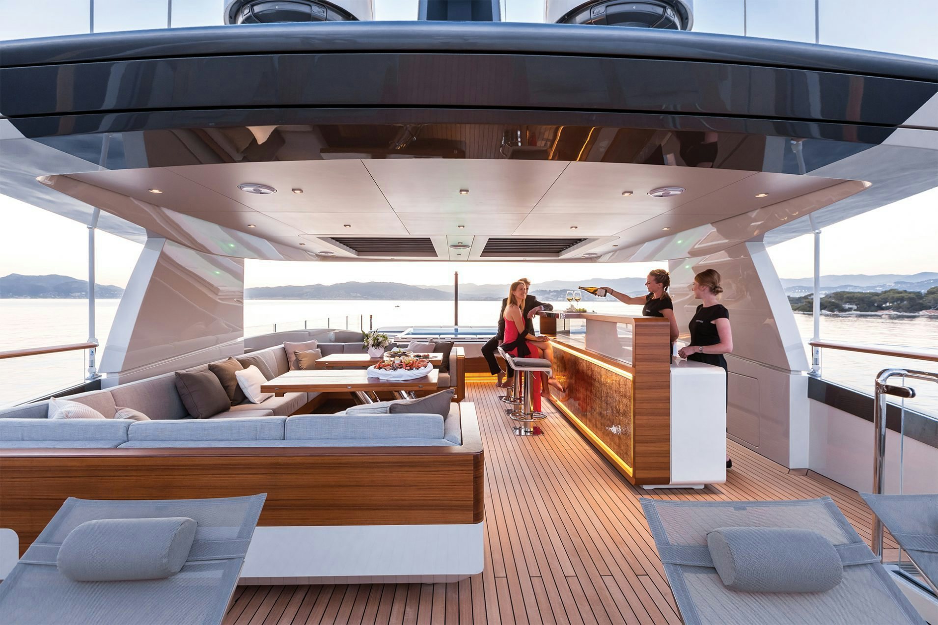 Luxury yacht charter, a couple enjoying pre-dinner drinks at the bar Luxury yacht charter, a couple enjoying pre-dinner drinks at the bar